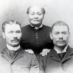 Alonzo Herndon with his mother, Sophenie, and his brother, Thomas, ca. 1890. About his early life Alonzo writes, &quotMy mother was emancipated when I was seven years old and my brother Tom five years old. She was sent adrift in the world with her two children and a corded bed and [a] few quilts. . . . She hired herself out by the day and as there was money in the country, she received as pay potatoes, molasses, and peas enough to keep us from starving."