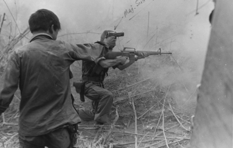 2 men in the heat of battle were photographed firing their guns