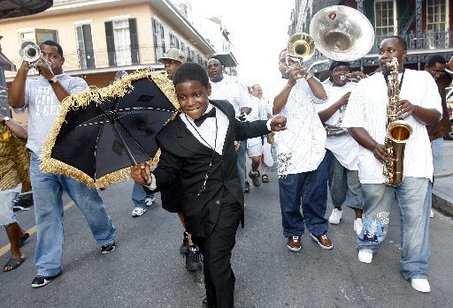 STAFF PHOTO BY MICHAEL DEMOCKER Friday, August 17, 2007 Eric Calhoun, 12, leads the Soul Rebels Brass Band down Royal Street during the first Friday French Quarter Brass Band parade and concert. The second-line parade, part of the new summer concert series produced by the French Quarter Business Association to celebrate the quarter and the city's brass bands, wound through the quarter accompanied by carriages and float riders, ending with a concert on the steps of the Louisiana Supreme Court Building.
