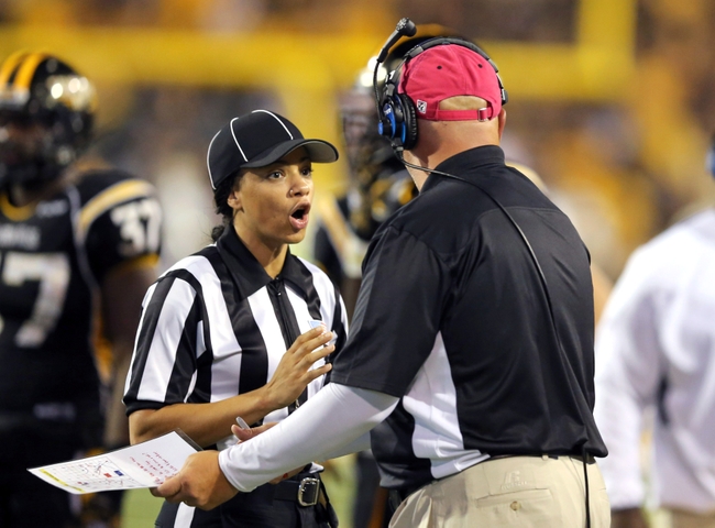 Sep 27, 2014; Hattiesburg, MS, USA; Official Maia Chaka talks to a Southern Miss Golden Eagles assistant coach in the second quarter of their game against the Rice Owls at M.M. Roberts Stadium. Mandatory Credit: Chuck Cook-USA TODAY Sports