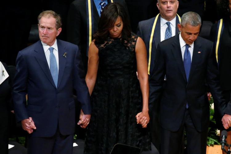 Former President George W. Bush (from l.), First Lady Michelle Obama and President Obama join hands during the memorial service.